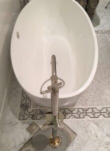 Oval tub with free standing faucet